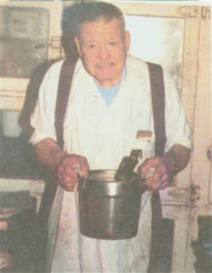 Charles Hall holding a pot of food